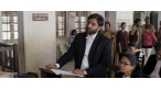 Vivek Gomber (standing) as Vinay Vora in COURT. A film by Chaitanya Tamhane. A Zeitgeist Films release.
