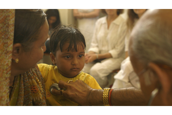 Dr. Vasant Lad with a young patient in THE DOCTOR FROM INDIA. A film by Jeremy Frindel. A Zeitgeist Films release.